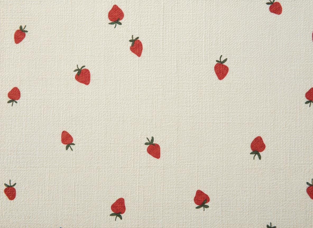 A cream-coloured fabric featuring a repeating pattern of small, red strawberries with green stems. The material has a visible, fine-textured weave throughout, providing a consistent background for the evenly spaced fruit illustrations.