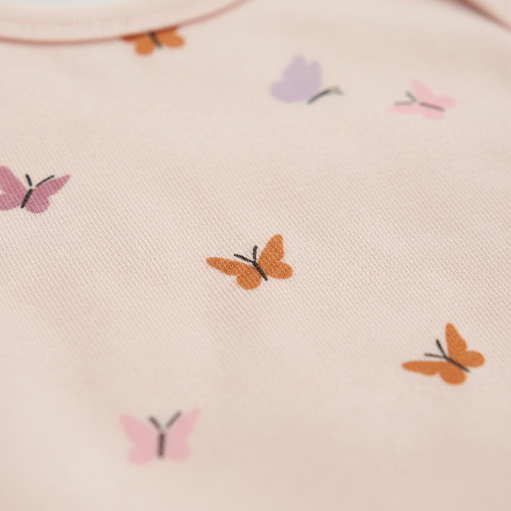 A light pink fabric garment featuring a repeating pattern of small butterflies in various colours including orange, lavender, and dusty rose. Each butterfly is depicted with simple, clean lines and a solid fill, creating a consistent motif.