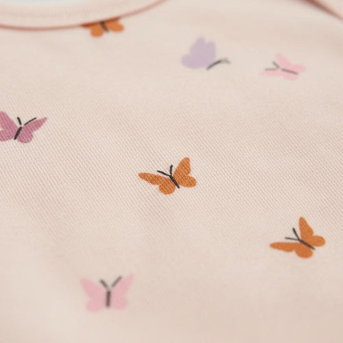 A light pink fabric garment featuring a repeating pattern of small butterflies in various colours including orange, lavender, and dusty rose. Each butterfly is depicted with simple, clean lines and a solid fill, creating a consistent motif.