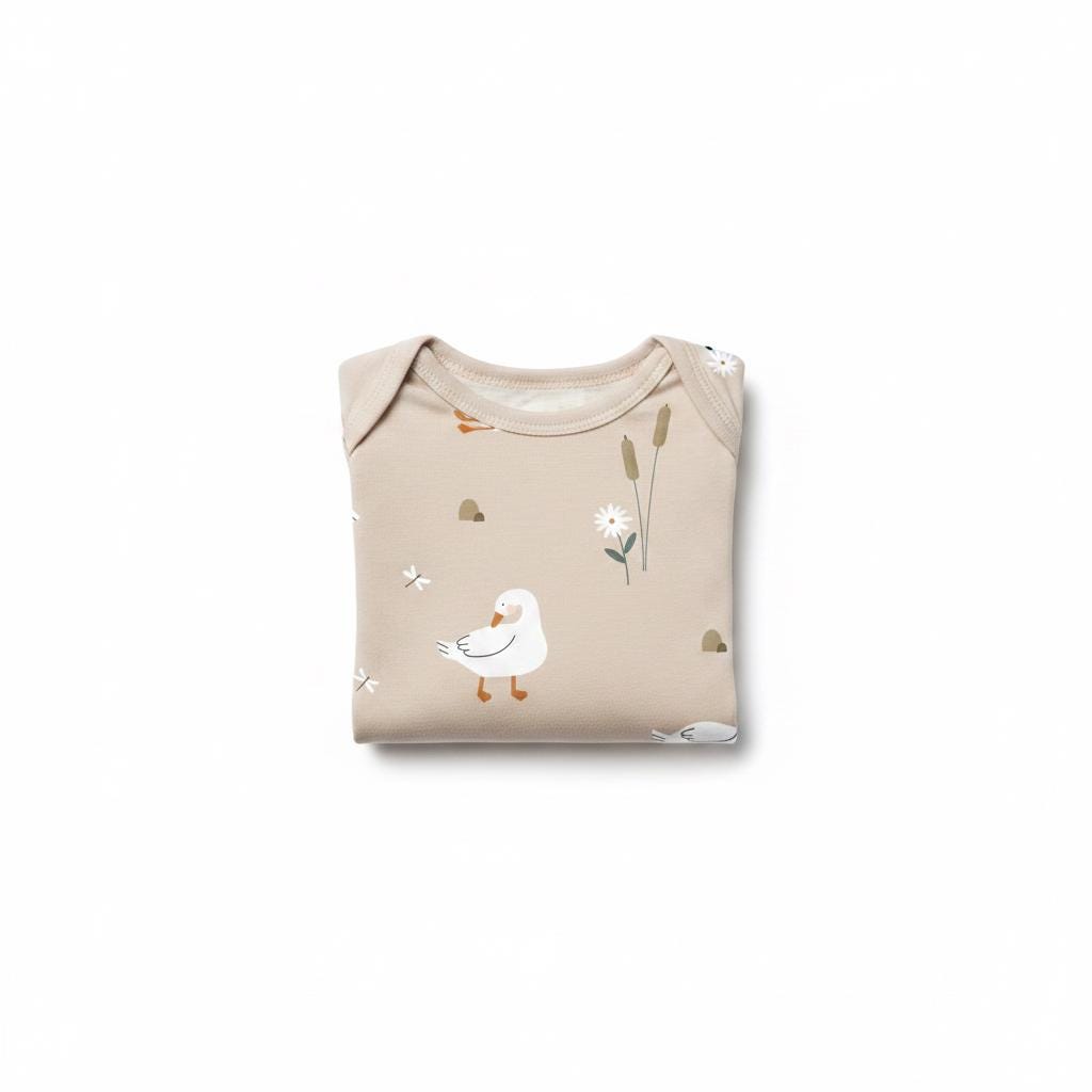 A folded beige baby bodysuit featuring a repeating pattern of white geese, brown cattails, small white flowers, and tiny dragonflies. The garment has a round neckline and short sleeves, showcasing a soft, neutral-toned fabric design.