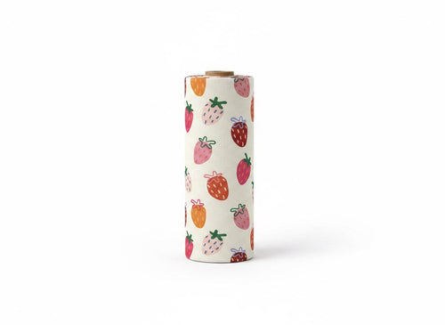A cylindrical roll of fabric featuring a repeating pattern of hand-drawn style strawberries in shades of red, pink, and orange with green stems on a cream-coloured background. The roll has a visible brown cardboard core at the top.