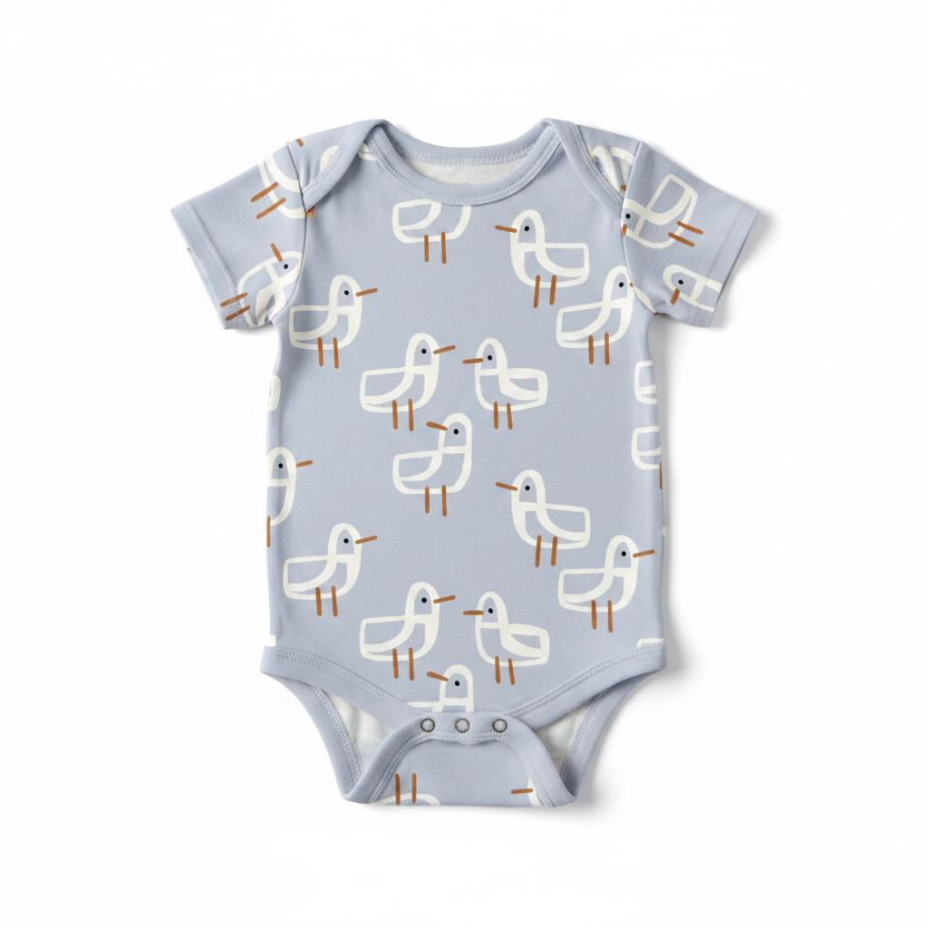 A light blue short-sleeved baby bodysuit featuring an all-over pattern of stylised white seagulls with dark blue eyes and brown legs. The garment has a round neckline and three metal snap closures at the bottom for easy access.