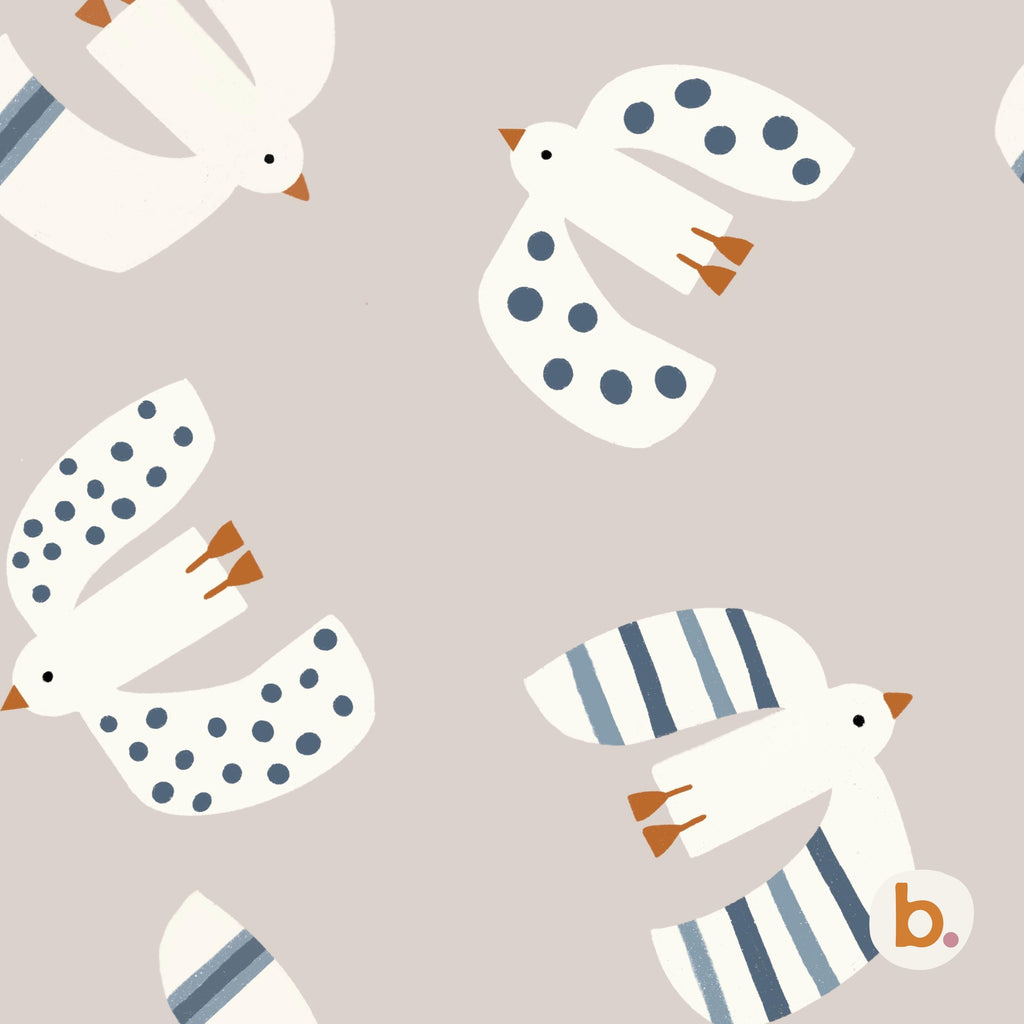 A repeating pattern on a light beige background featuring stylised white birds in flight. The birds have orange beaks and feet, with some wings displaying blue polka dots and others featuring blue vertical stripes. A small logo with the letter b.