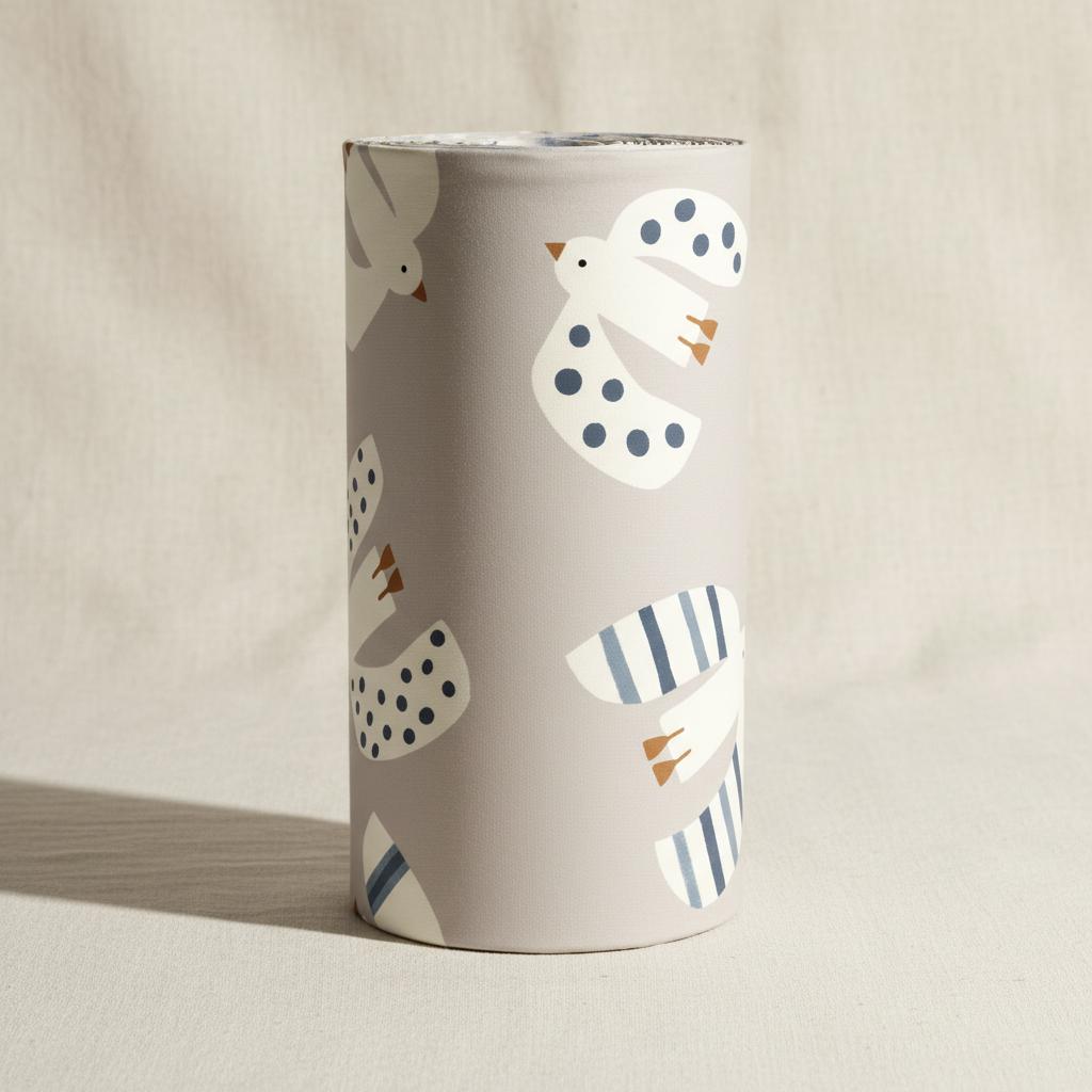 A cylindrical vase with a light grey background featuring a repeating pattern of stylised white birds. The birds are decorated with dark blue polka dots or vertical stripes and have small orange beaks and feet, creating a simple design.