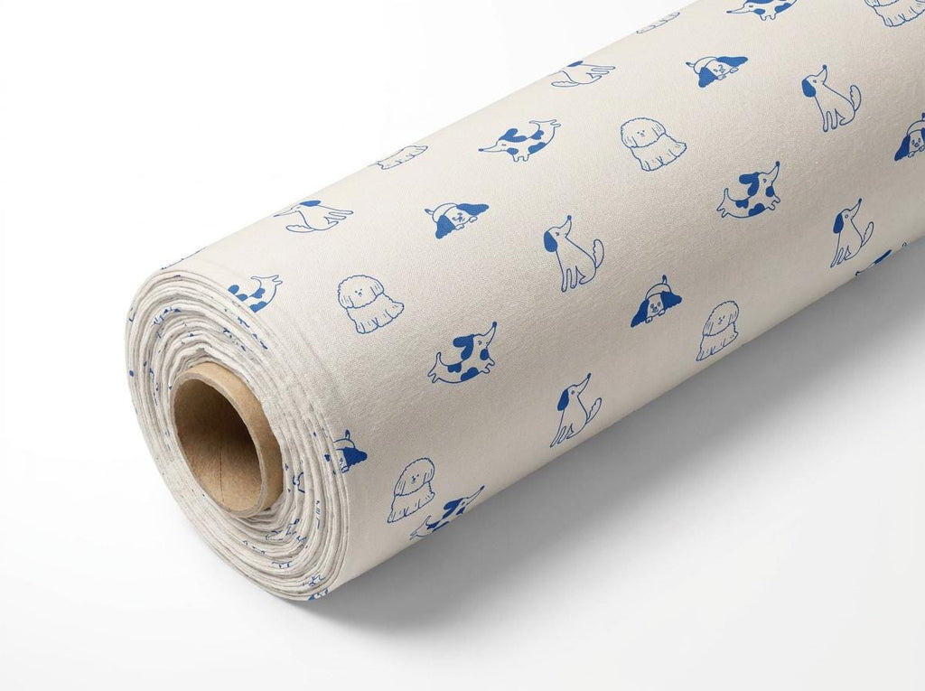 A roll of off-white fabric featuring a repeating pattern of small, blue line-art illustrations of various dog breeds in different poses, including sitting, lying down, and standing, with a cardboard core visible at the end.