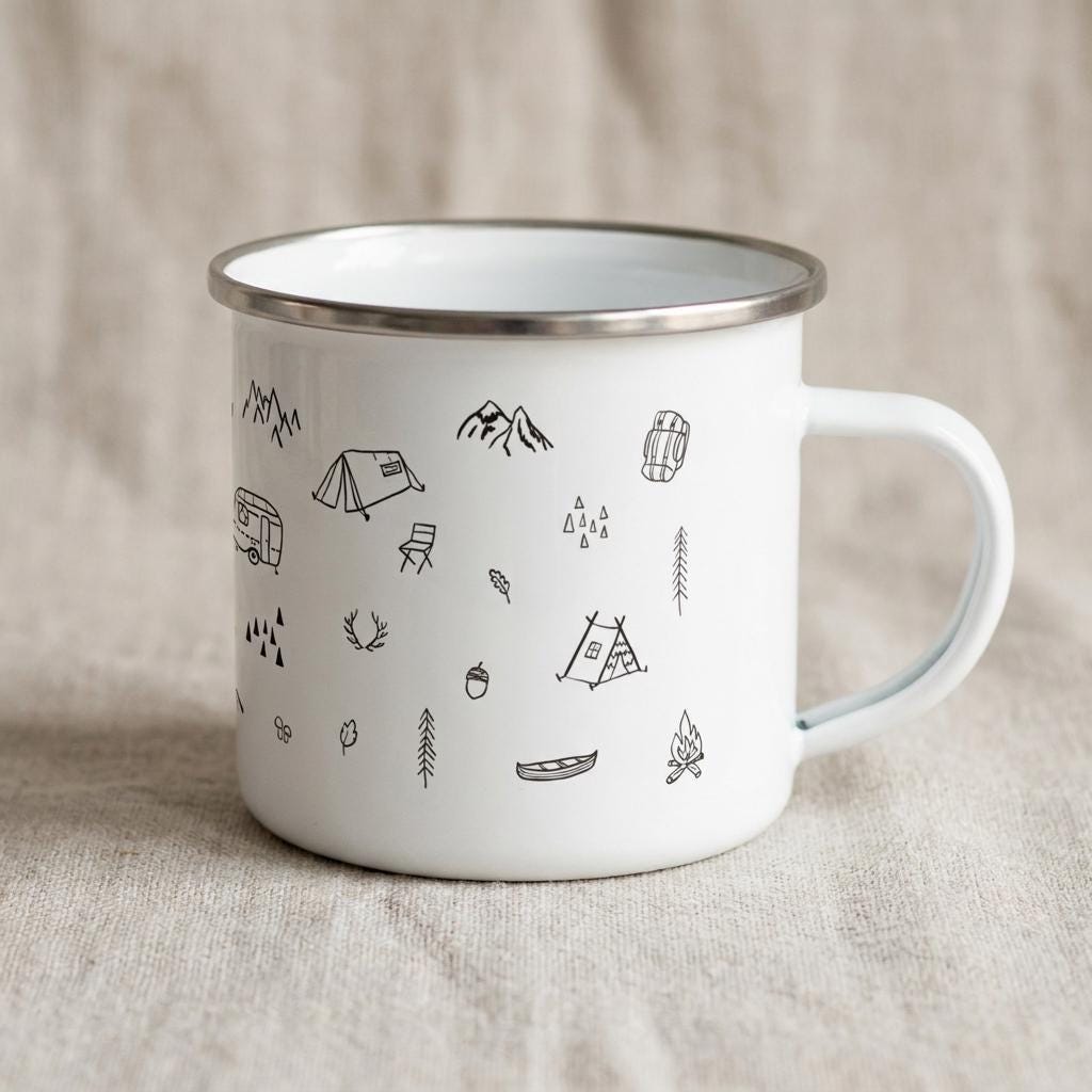 Camping enamel mug with the handle on the right, decorated with black outdoor doodles of tents, a campervan, canoe and pine trees.