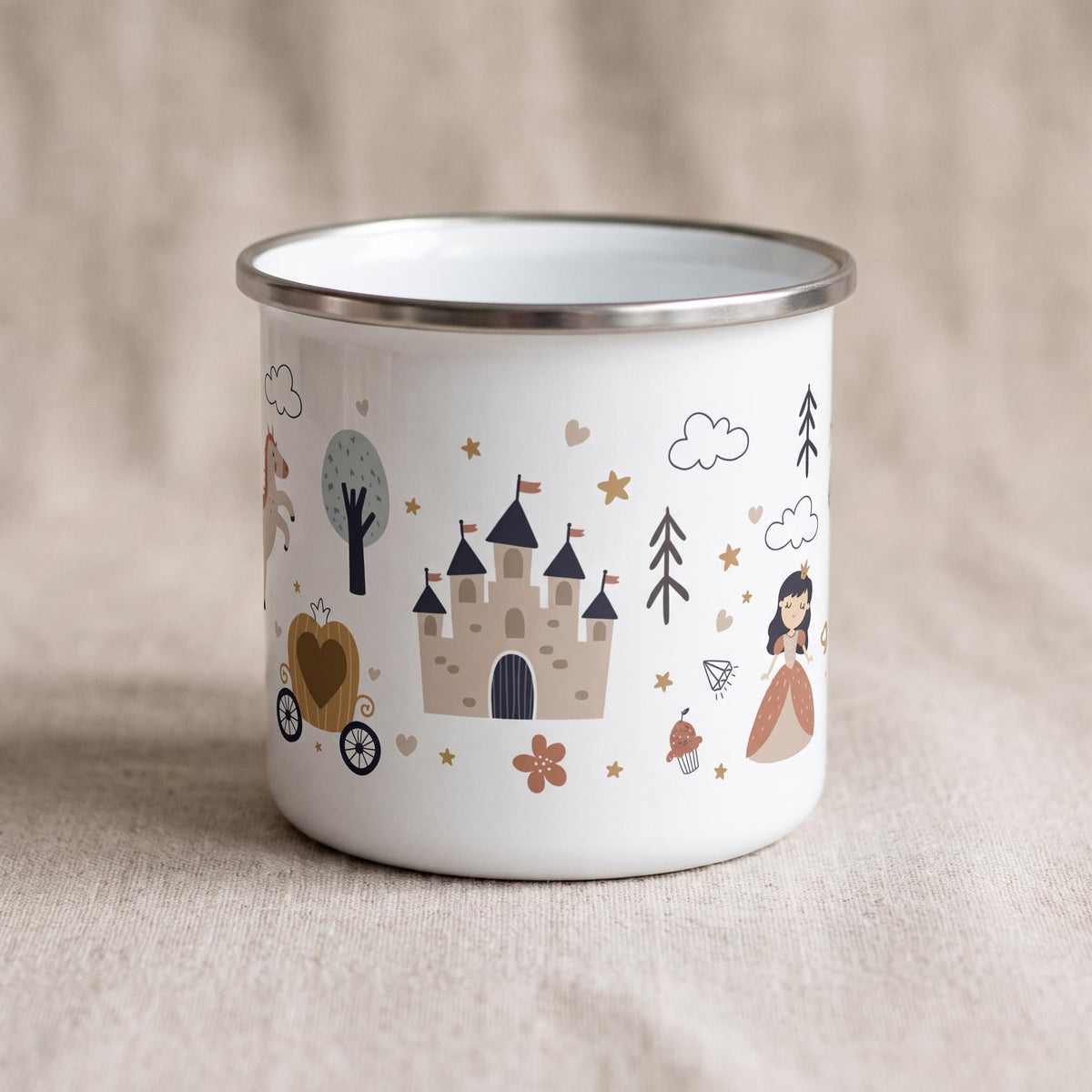 A white enamel mug with a silver-toned rim featuring a repeating pattern of brown castles, a horse-drawn carriage, a princess figure, trees, clouds, stars, and hearts in muted earth tones printed around the exterior surface.