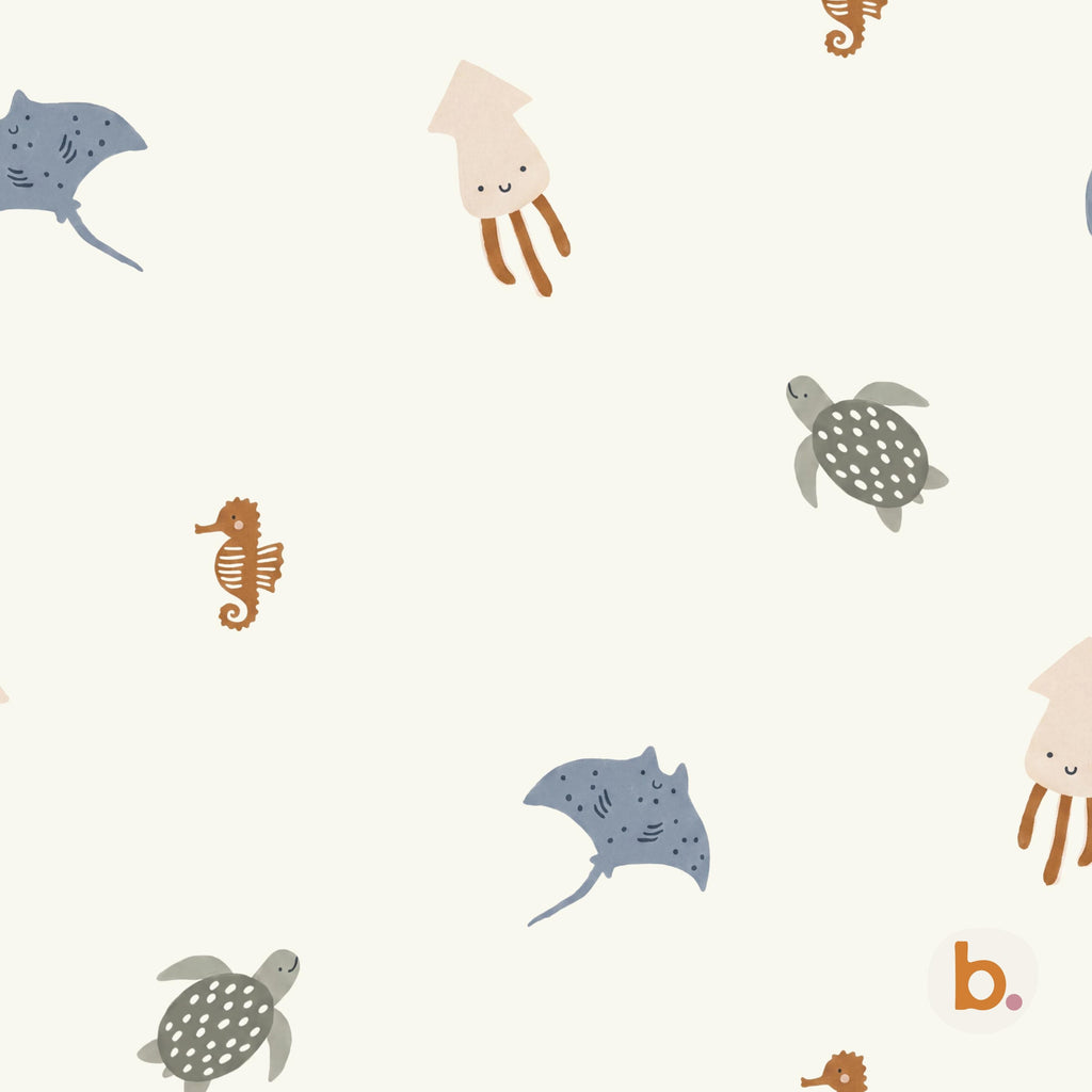 A repeating pattern on a cream background featuring illustrations of blue stingrays with white spots, light brown squids, grey sea turtles with white spots, and brown seahorses. A small orange letter b with a purple dot is in the corner.