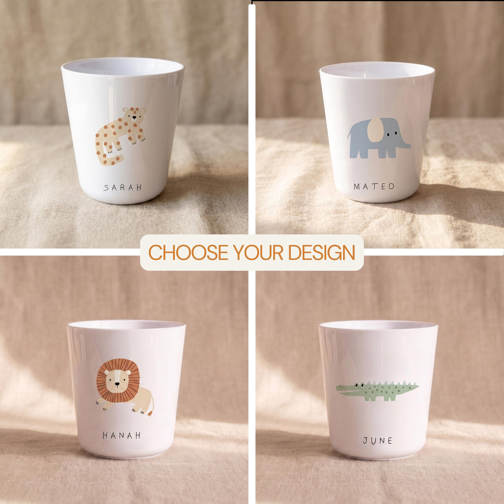 Four white cups featuring animal illustrations and names. Top left: a tan leopard with the name Sarah. Top right: a blue elephant with the name Mateo. Bottom left: a lion with the name Hanah. Bottom right: a green crocodile with the name June.