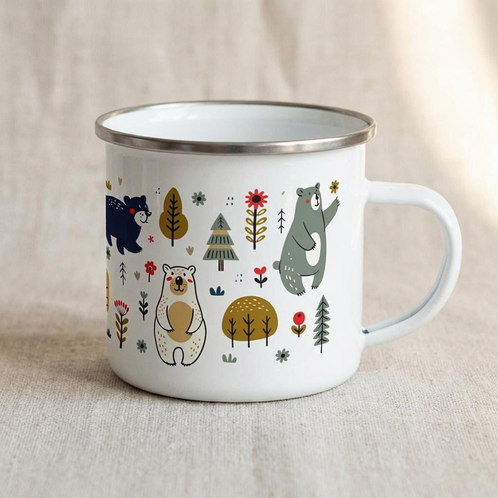A white enamel mug with a silver rim displays a woodland pattern of bears, trees, and flowers against a neutral fabric background.