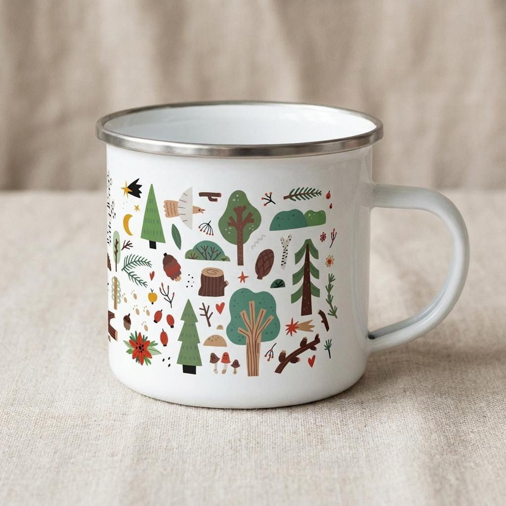A white enamel mug with a silver rim and handle is angled on a linen-textured background, showing a pattern of trees, plants, and woodland creatures.