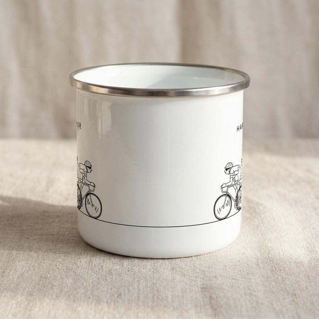 A close-up view of the back side of the white enamel mug resting on a fabric backdrop.