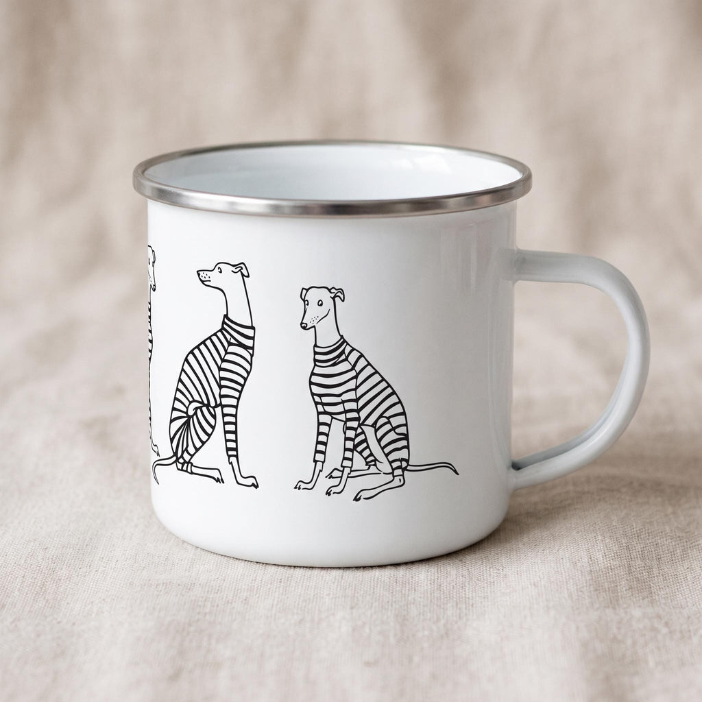 A white enamel mug with a silver-toned rim and a handle, featuring a black line art illustration of several greyhound dogs wearing striped sweaters. The dogs are depicted in various sitting and standing poses around the mug exterior.