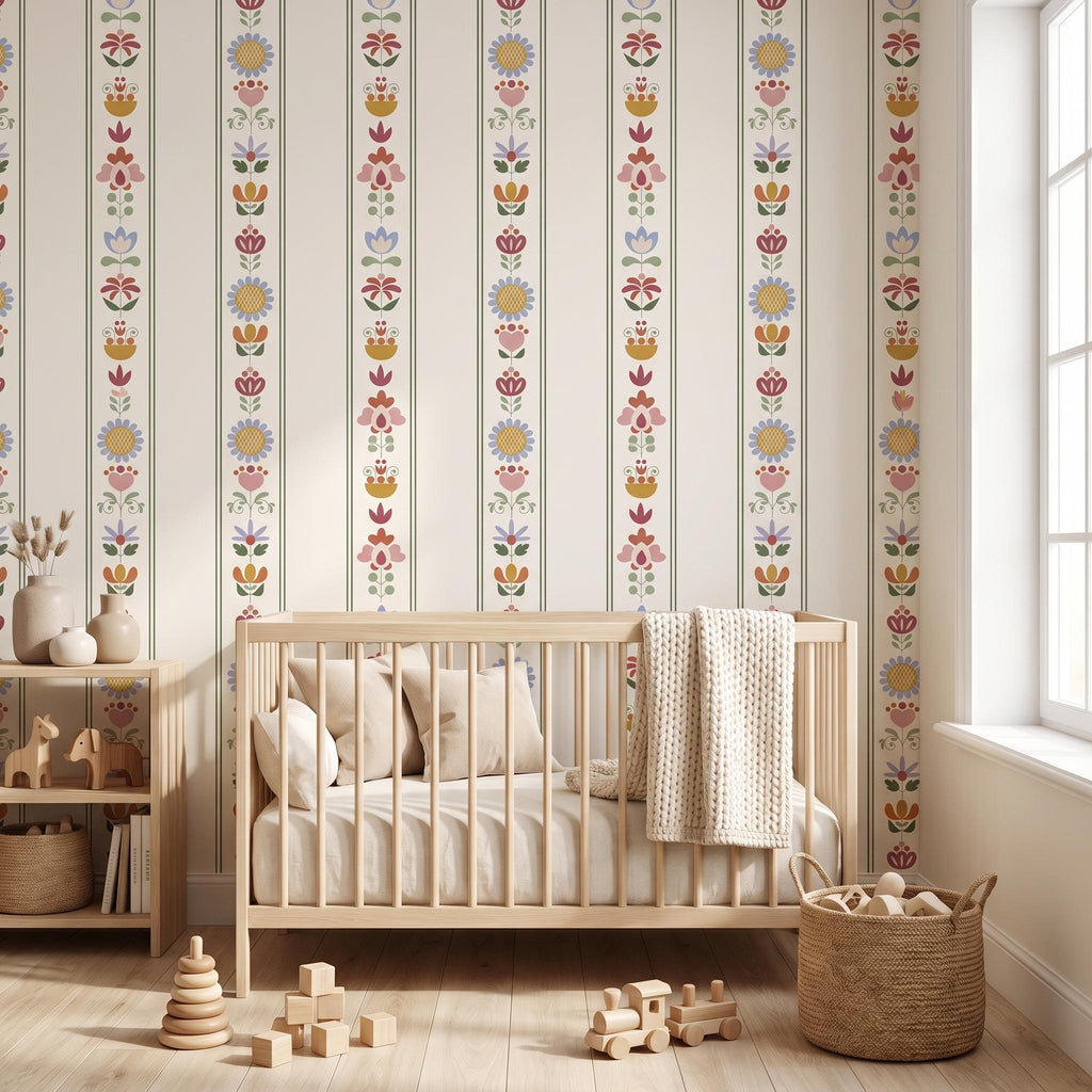 Wallpaper featuring vertical stripes with a repeating floral pattern in muted tones of yellow, pink, blue, and green on an off-white background. The design includes stylised flowers and leaves arranged in a symmetrical, linear sequence.