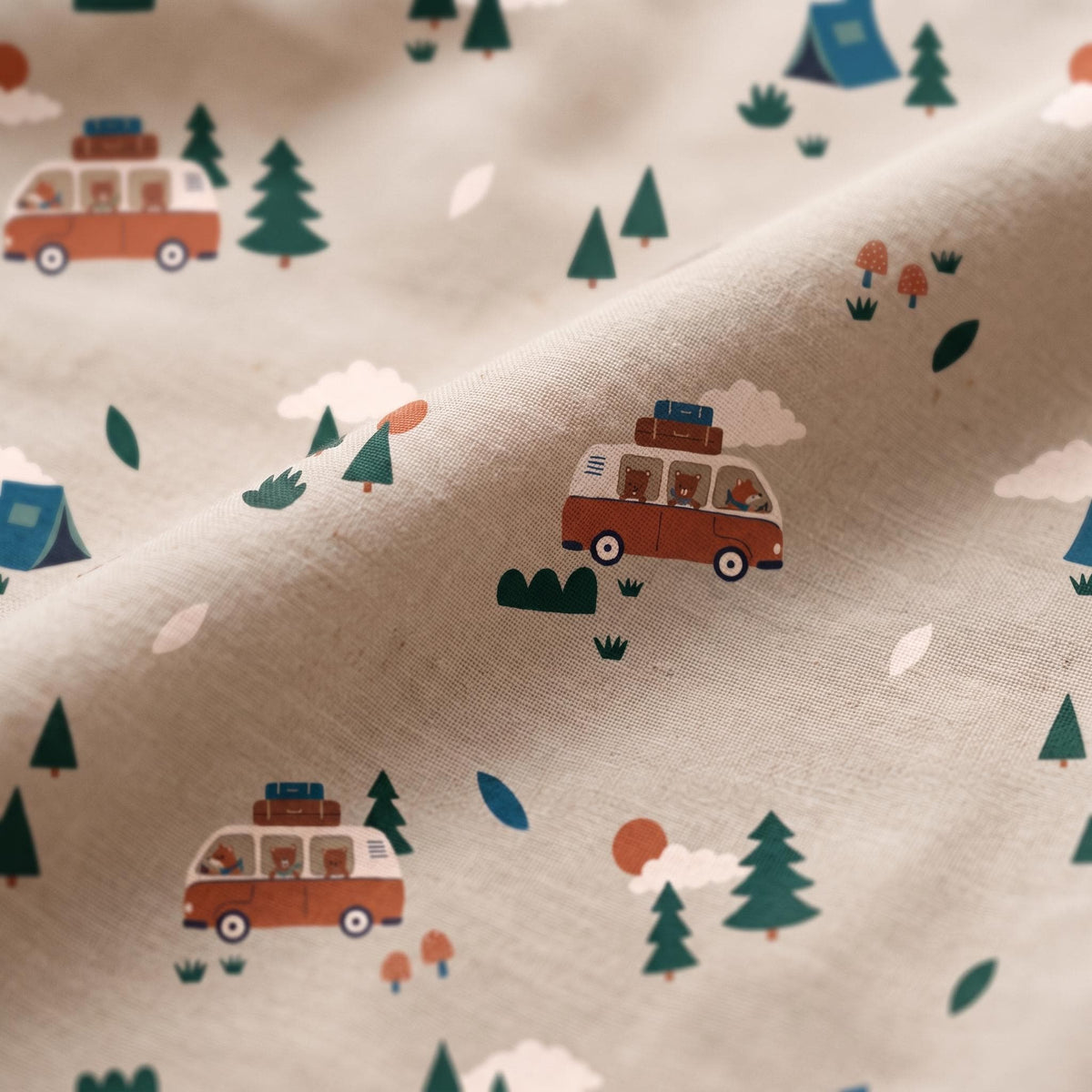 A light beige fabric featuring a repeating pattern of orange and white camper vans, green pine trees, blue tents, white clouds, small orange mushrooms, and brown bears visible through the windows of the vehicles in a camping scene.