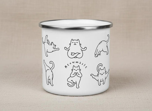 Studio product shot of the white enamel cat yoga mug standing upright on a neutral fabric surface.