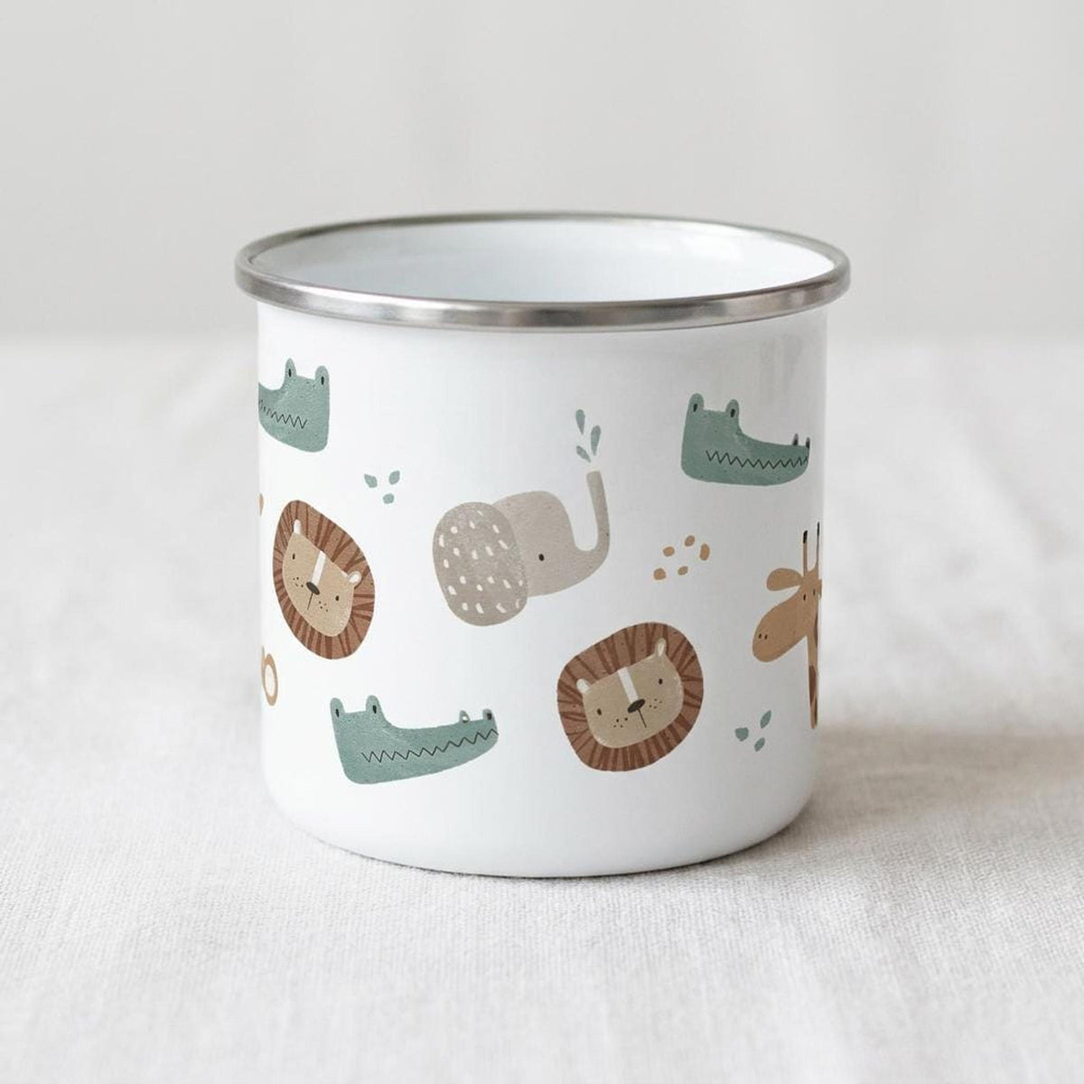 A plain white enamel camping mug with a silver rim displays a pattern of repeating safari animals.