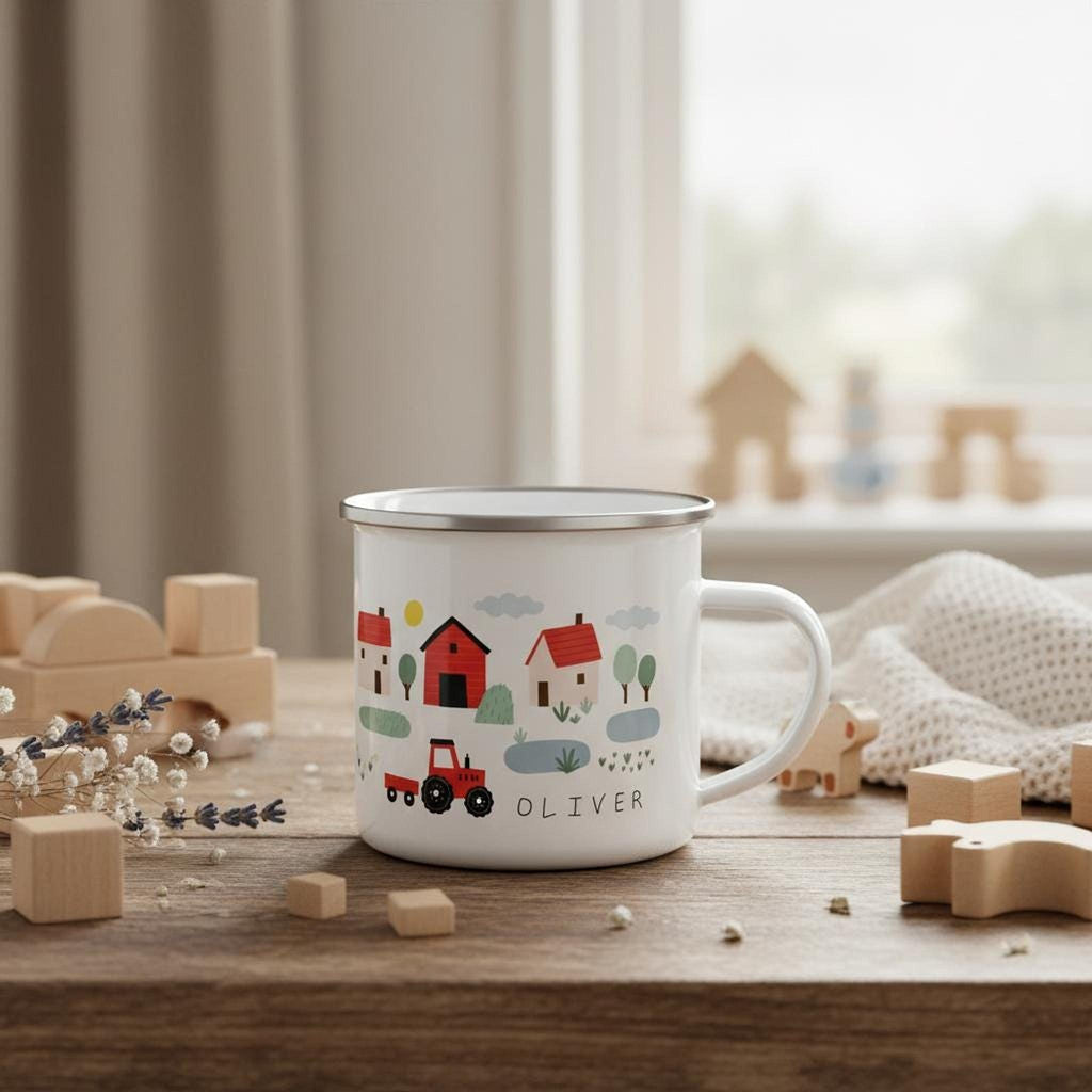 A white enamel mug featuring a farm scene with a red tractor and the name OLIVER rests on a wooden table with wooden toys.