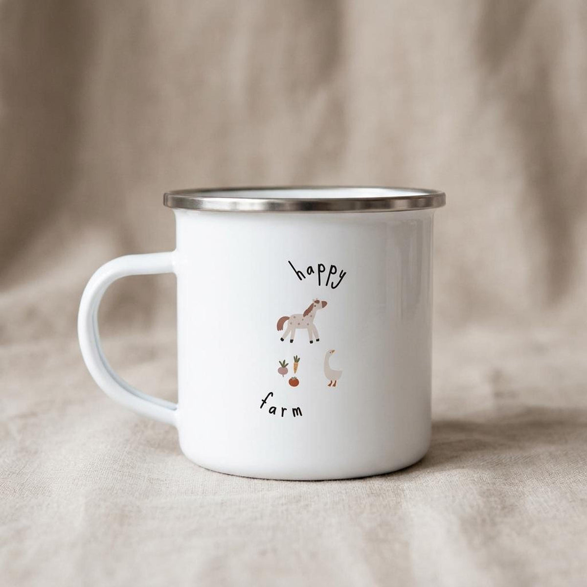 A white enamel mug with a silver rim features a happy farm illustration with a horse, carrot, and goose alongside text reading happy farm.