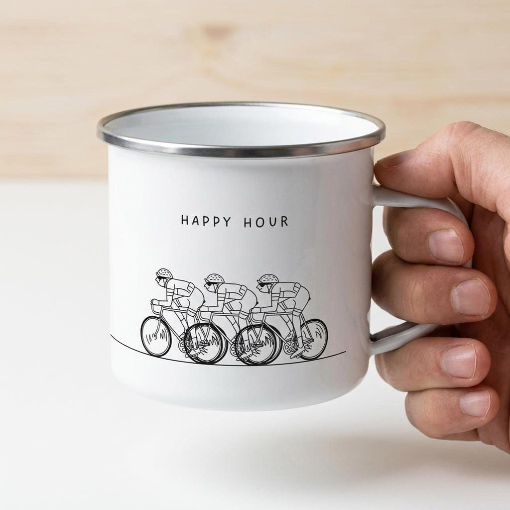 A hand holds the white enamel mug displaying the cyclist illustration and HAPPY HOUR text.