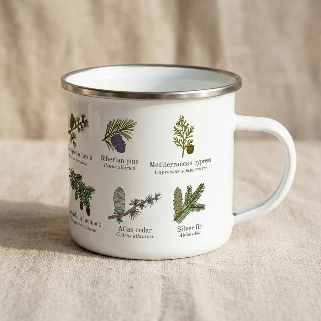 The white enamel mug is angled to show illustrations of Mediterranean cypress, Siberian pine, and silver fir.