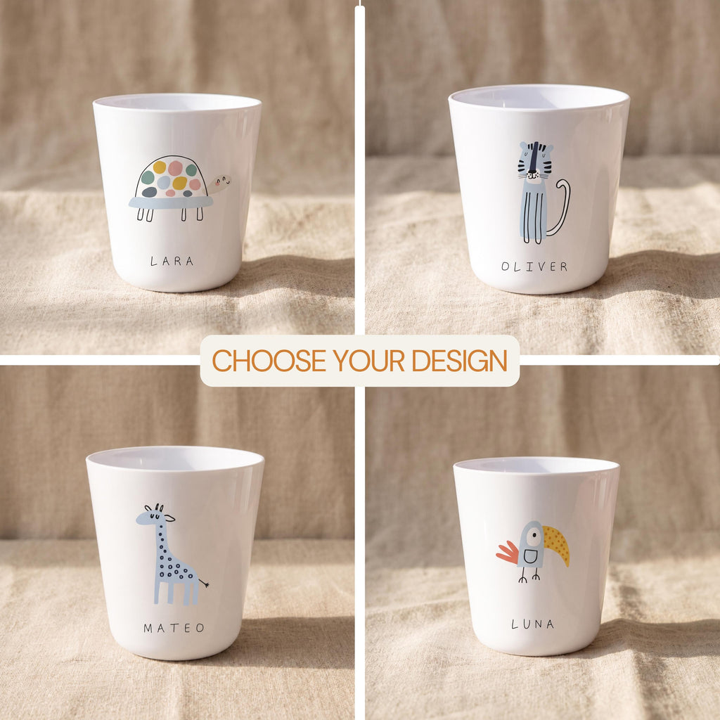 Four white cups featuring animal illustrations and names. The top left cup shows a turtle labelled LARA, the top right a tiger labelled OLIVER, the bottom left a giraffe labelled MATEO, and the bottom right a toucan labelled LUNA. Text reads CHOOSE YOUR DESIGN.