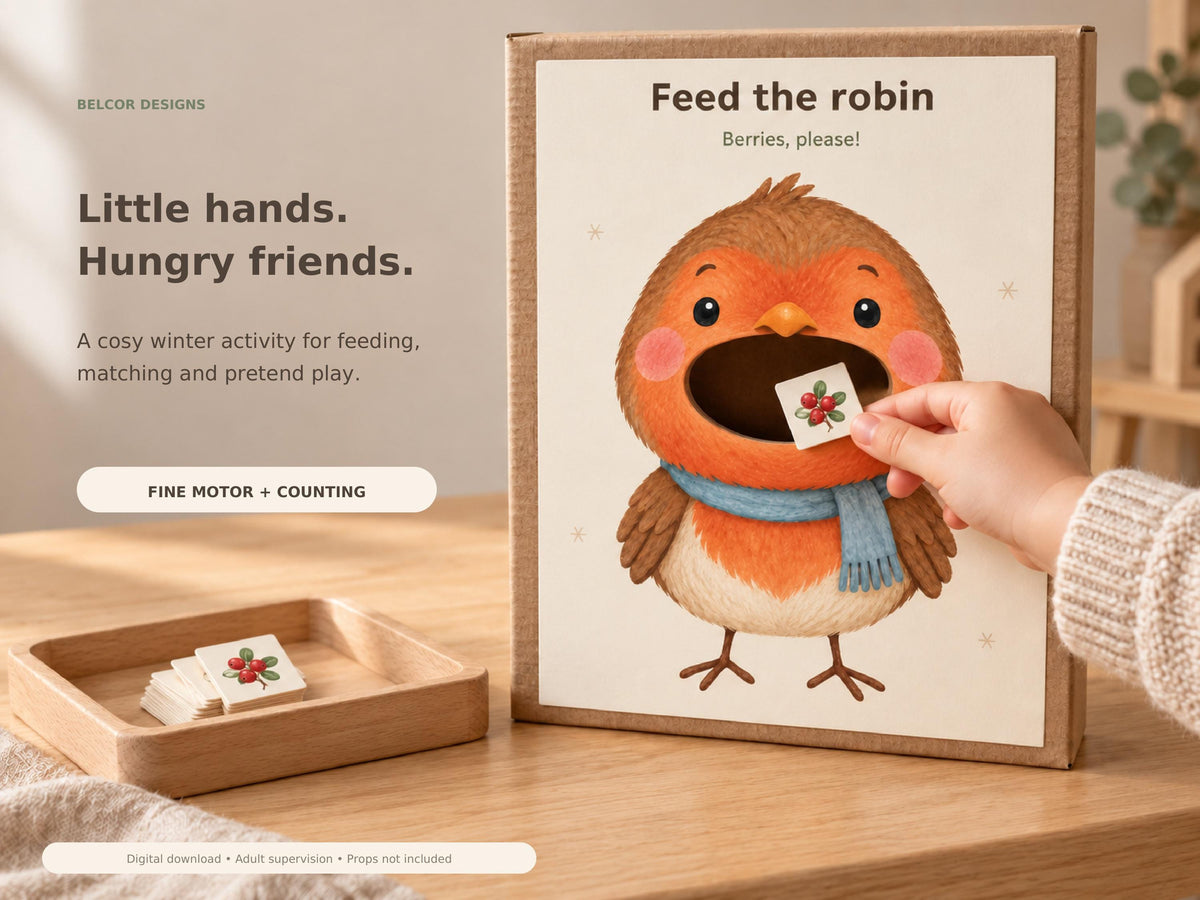 A child holds a small woodland berry card at the cut-out mouth of the robin feeding printable, mounted on a cardboard box beside a wooden tray of paper cards.