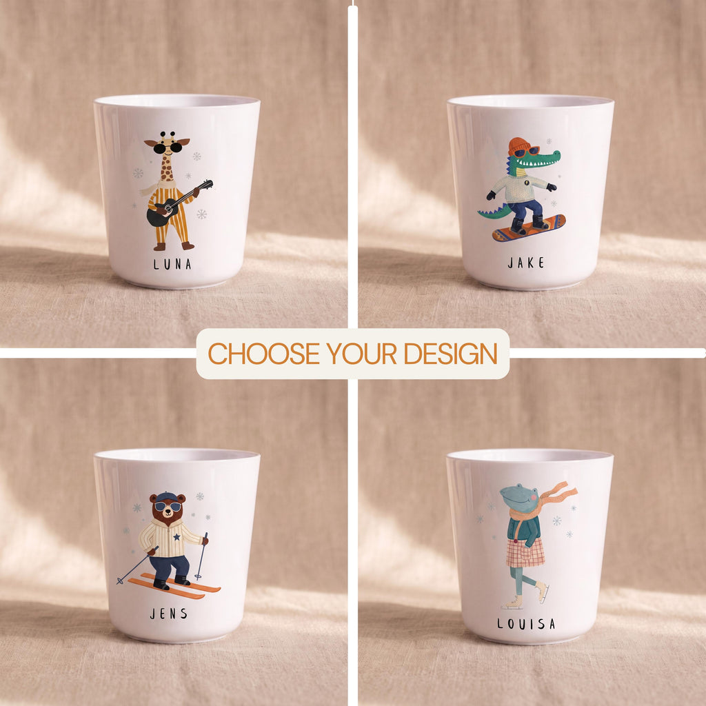 A four-panel grid showing different white children's cups with illustrations of a giraffe playing a guitar, a crocodile on a snowboard, a bear skiing, and a frog ice skating.