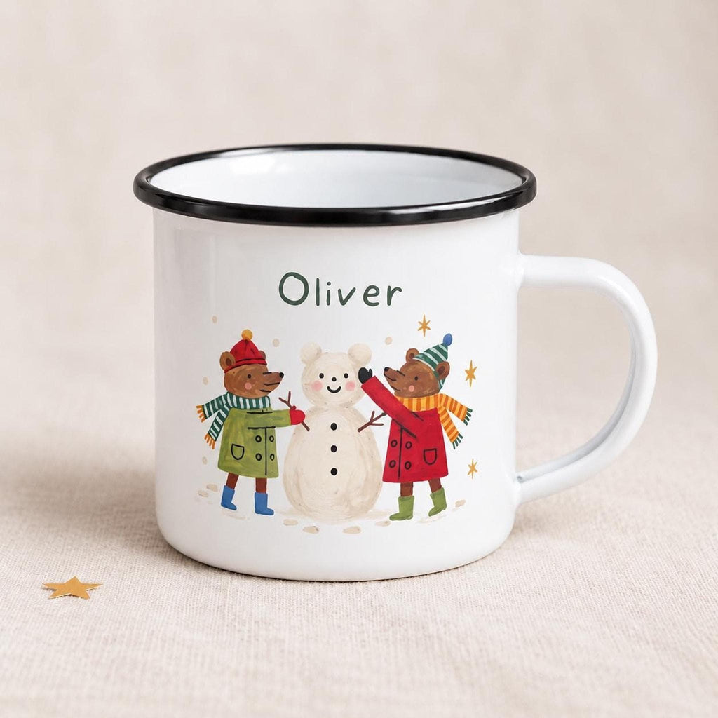A white enamel mug with a black rim displaying the name Oliver and two bears building a snowman.