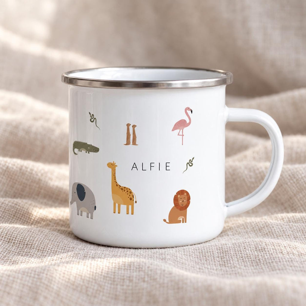 A white enamel mug with a silver rim and handle, featuring a colourful pattern of various safari animals including a giraffe, elephant, lion, flamingo, crocodile, meerkats, and snakes, with the name ALFIE printed in black text.