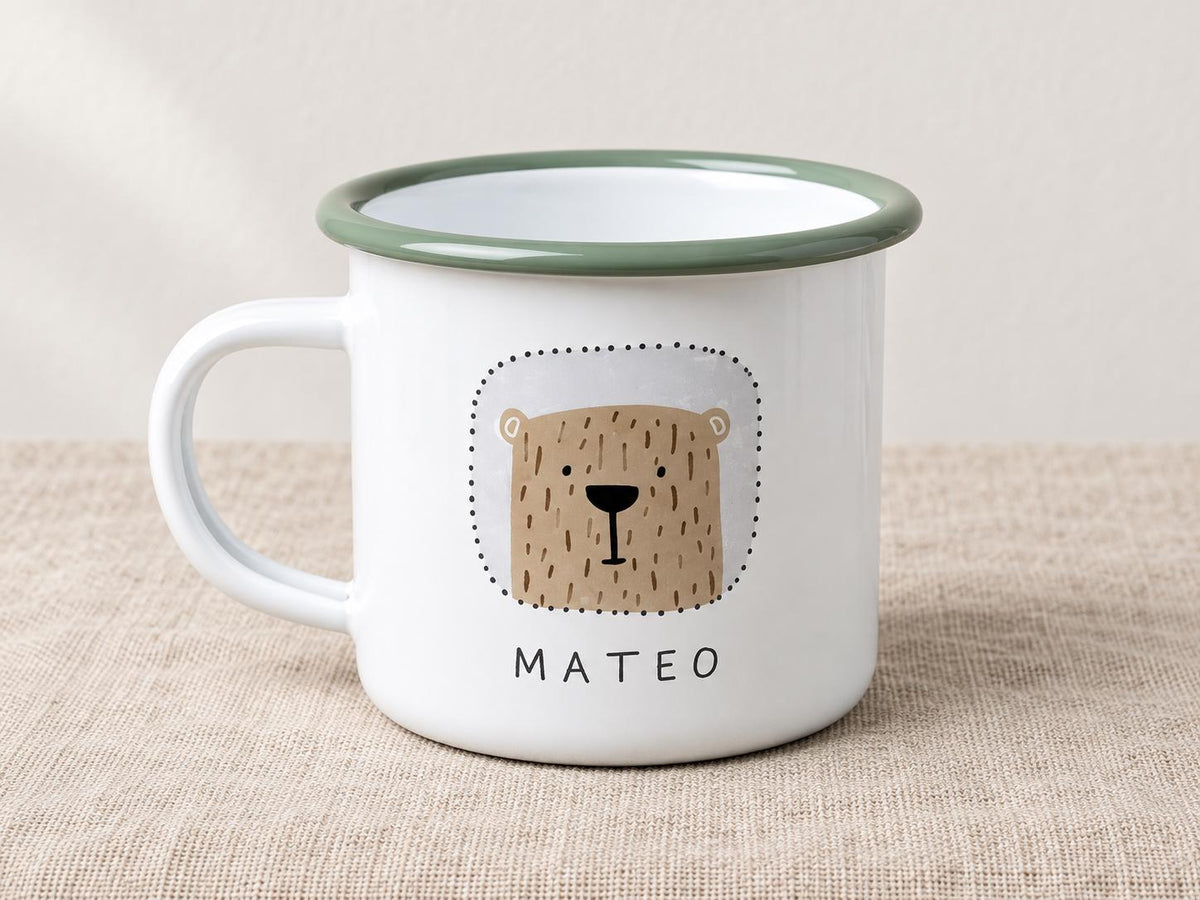 White enamel kids mug with a sage green rim, decorated with a brown bear face and the name MATEO.