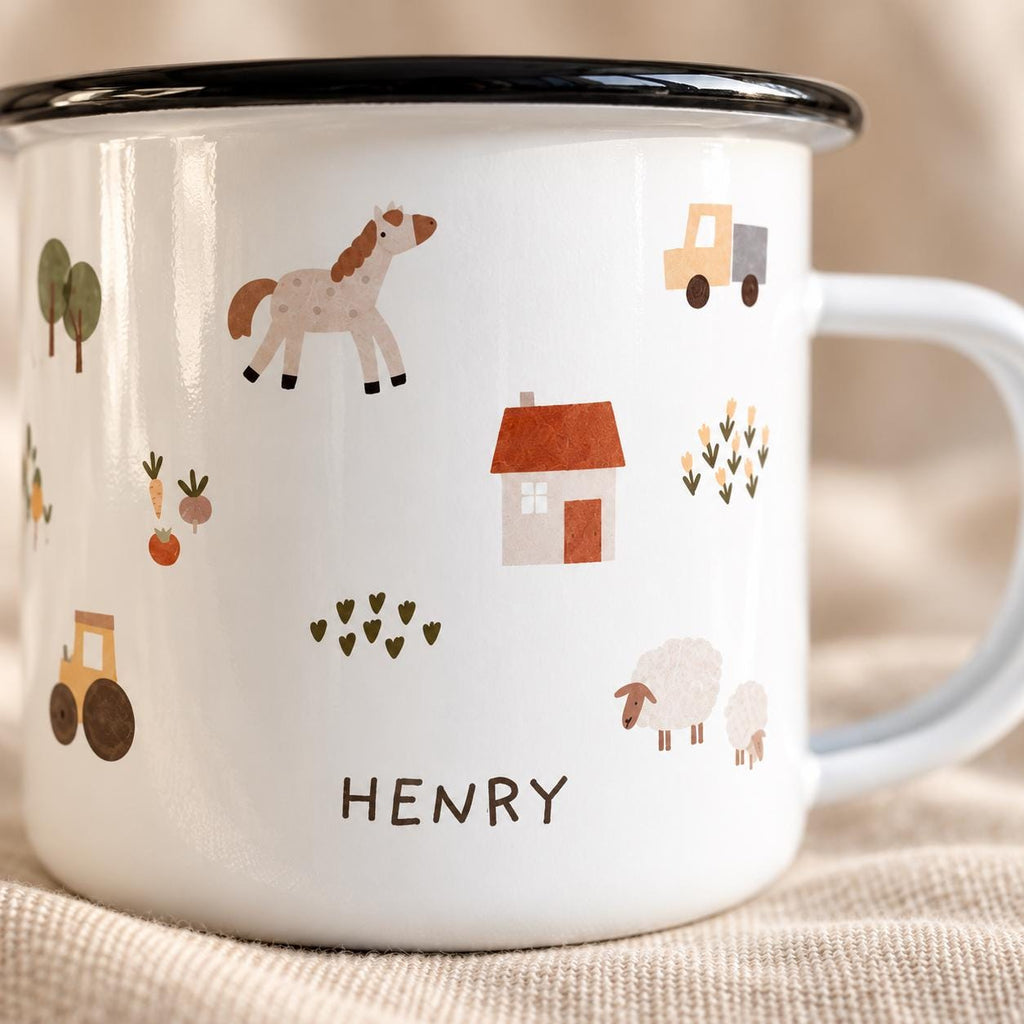 A white enamel mug with a black rim and a handle, featuring a repeating pattern of a horse, a house, a truck, a tractor, sheep, trees, and vegetables. The name HENRY is printed in dark brown capital letters on the front of the mug.