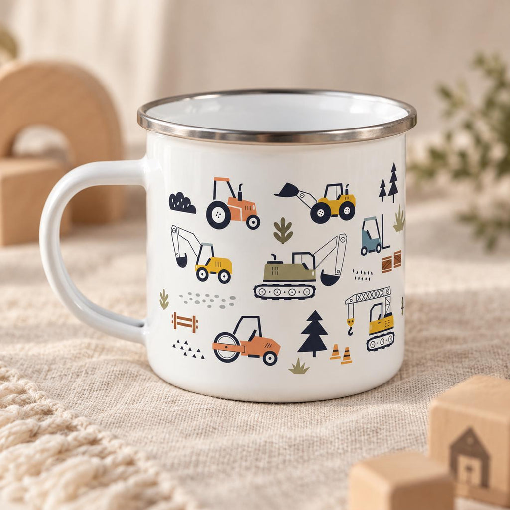 A white enamel mug with a silver rim featuring a repeating pattern of construction vehicles including tractors, excavators, a crane, and a road roller, interspersed with small trees, traffic cones, and various geometric shapes.