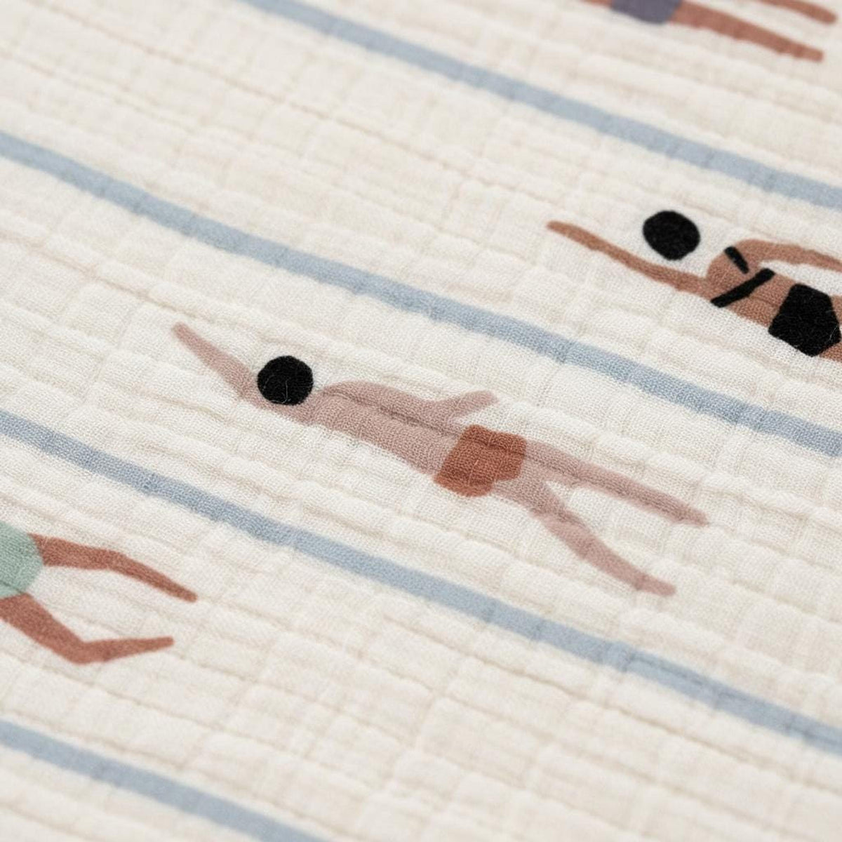 Close-up of textured fabric featuring a repeating print of swimmers in blue lanes.
