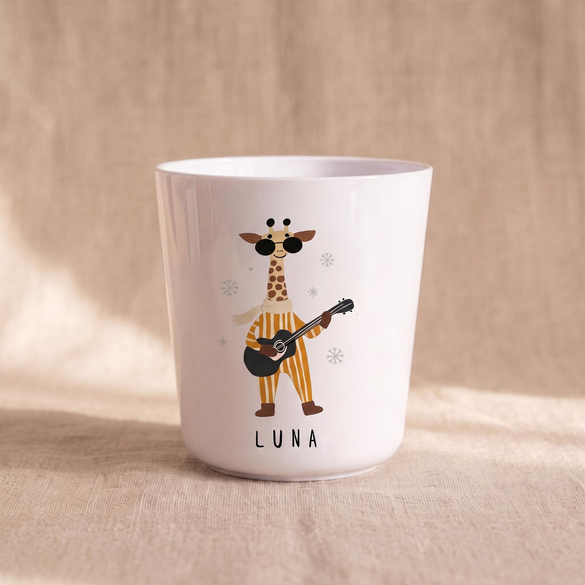 A single white child's cup featuring an illustration of a giraffe wearing sunglasses and playing a guitar, with the name Luna printed below.