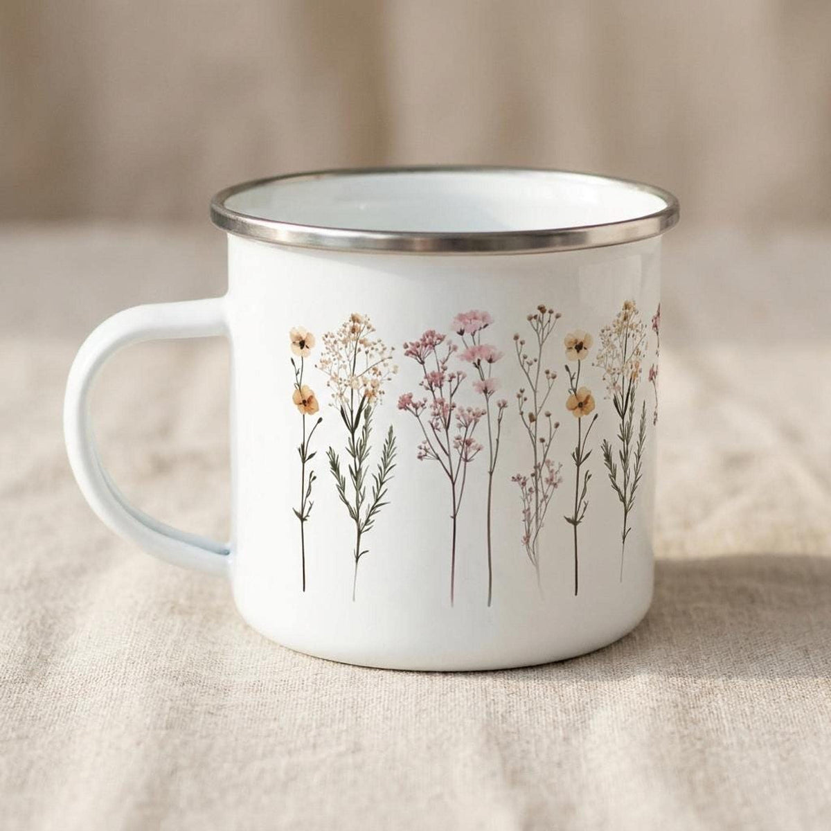 A third angle of the botanical enamel mug, highlighting the handle and delicate wildflower pattern.