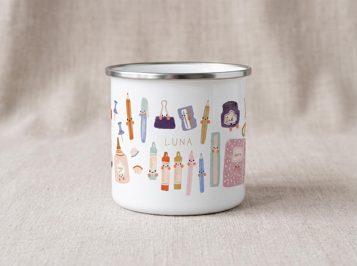 A front view of a white enamel mug with a silver rim featuring cute cartoon school supplies and the custom name Luna printed in the center.
