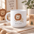 A white kids cup featuring a graphic illustration of a lion with a brown mane and the name NOLAN printed in black capital letters below the lion. The cup has a curved handle and a smooth, glossy finish on the exterior surface.