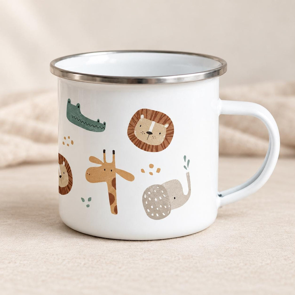 White enamel safari animal mug with a silver rim and right-side handle, shown on a light neutral surface. The wraparound print features a green crocodile, brown lion, ochre giraffe and grey elephant.